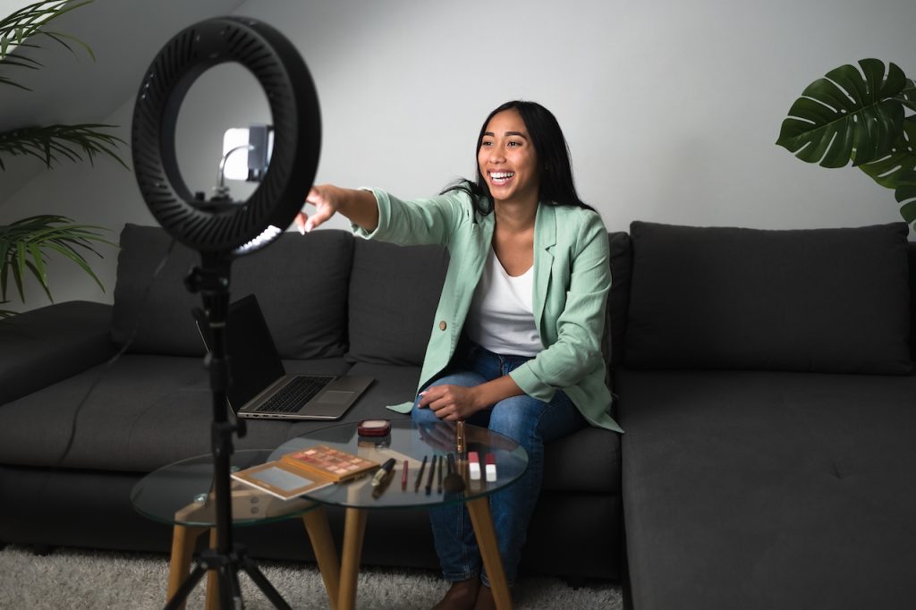 successful cam girl using a phone to brodcast